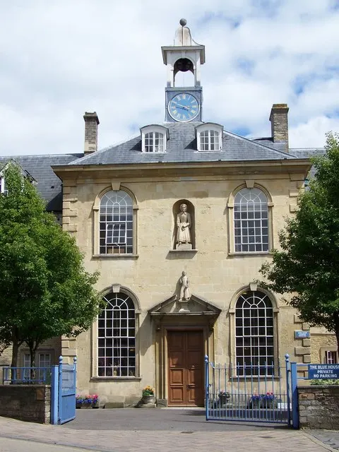 The Blue House almshouse standing beside the bridge over the river in Frome