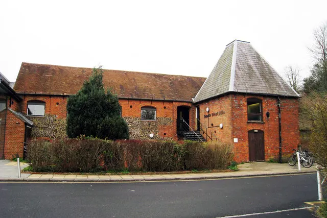 The long brick and tile buildings of Farnham Maltings beside the River Wey