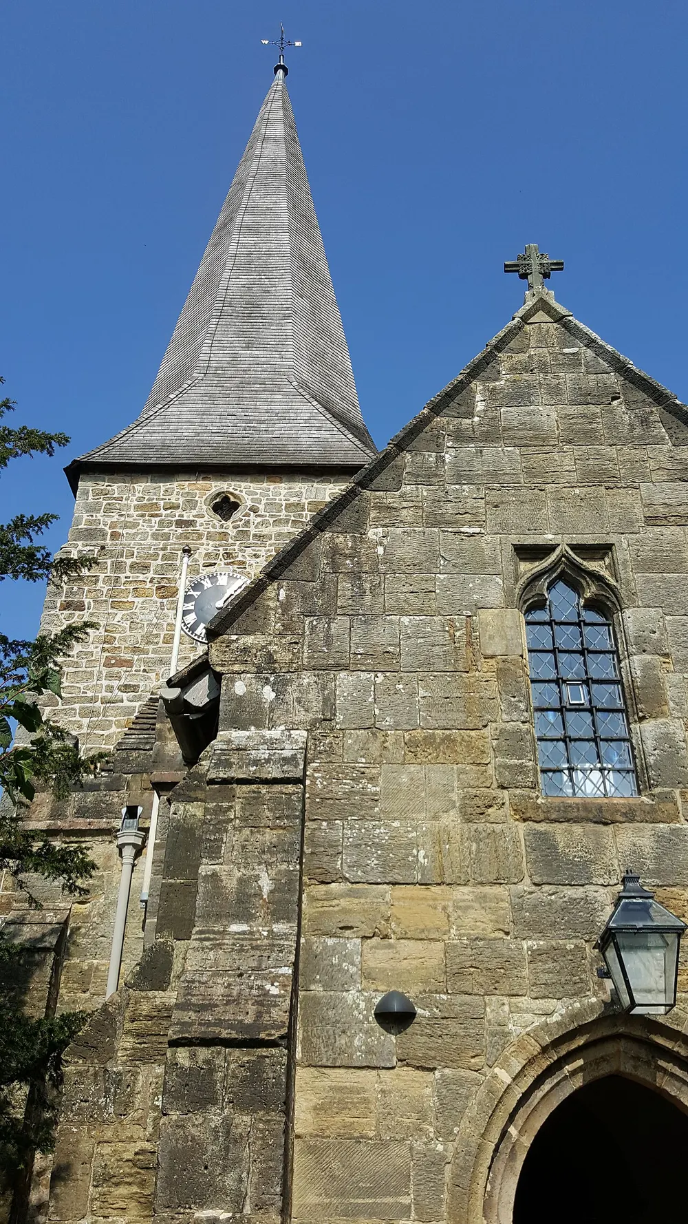 The spire of All Saints Church above the village pond at Lindfield near Haywards Heath